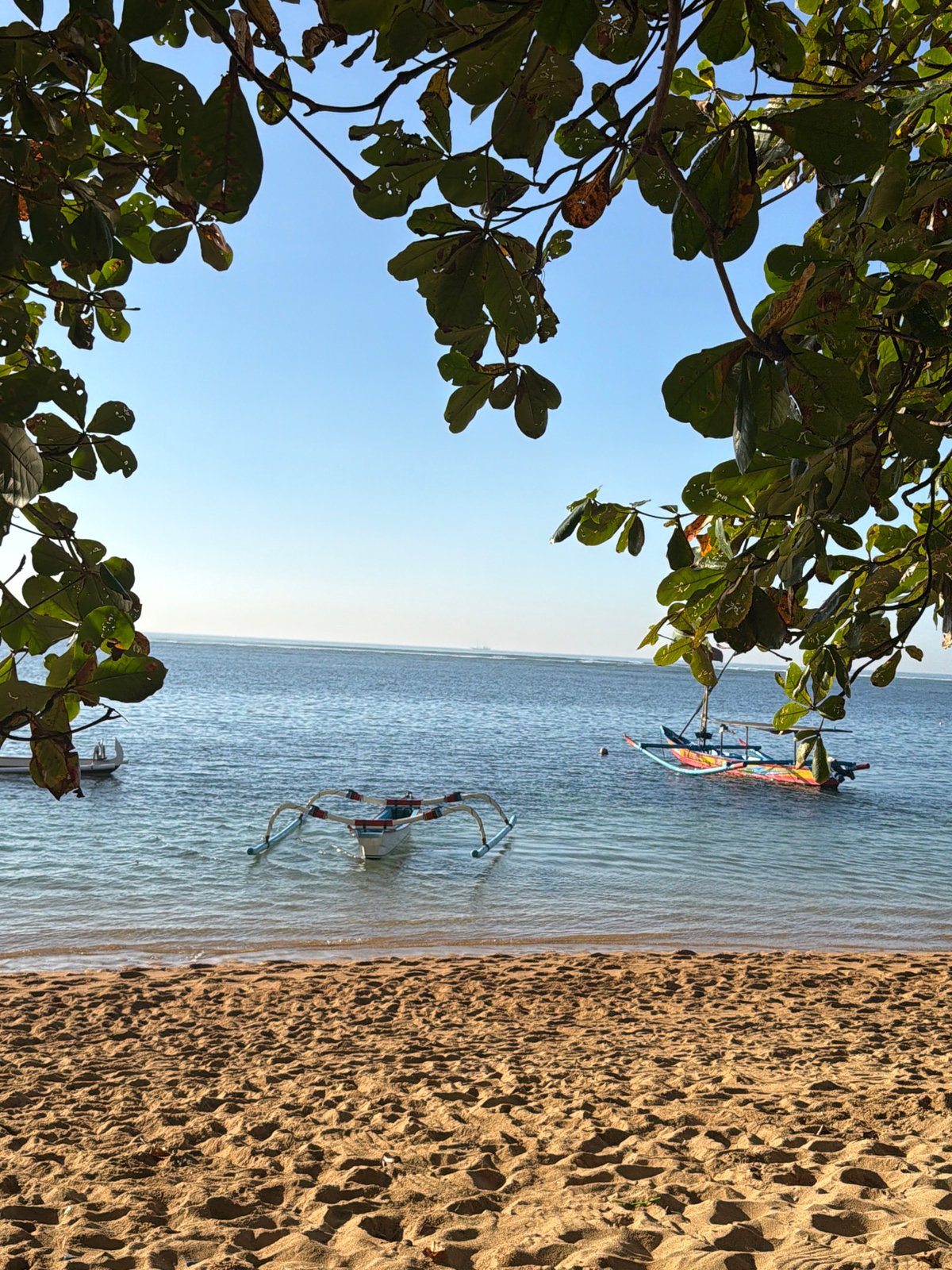 Quiet morning along Denpasar's beachfront path and shoreline