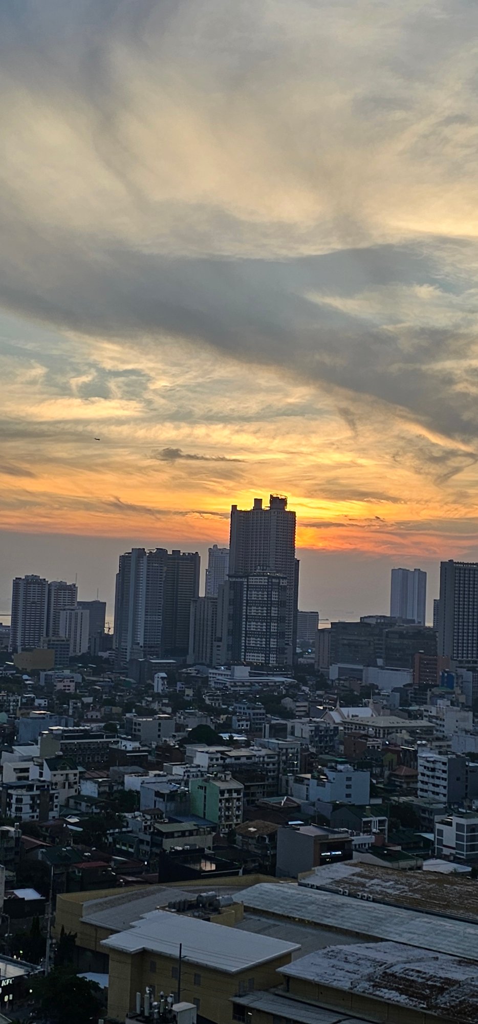 Makati skyline, elevated highway, and shifting morning skies