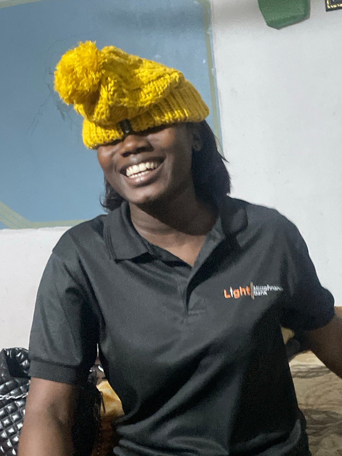 Light Microfinance Bank rep relaxes and poses in Jos