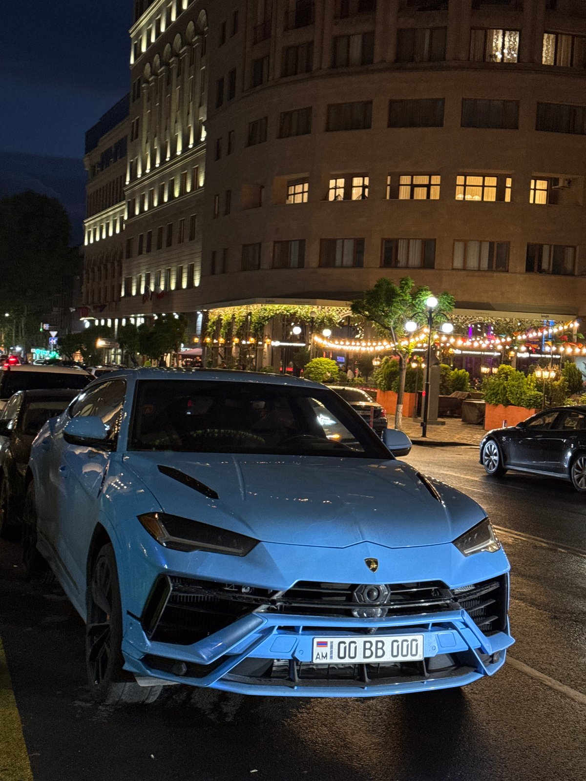 Luxury car draws attention in downtown Yerevan evening scenes