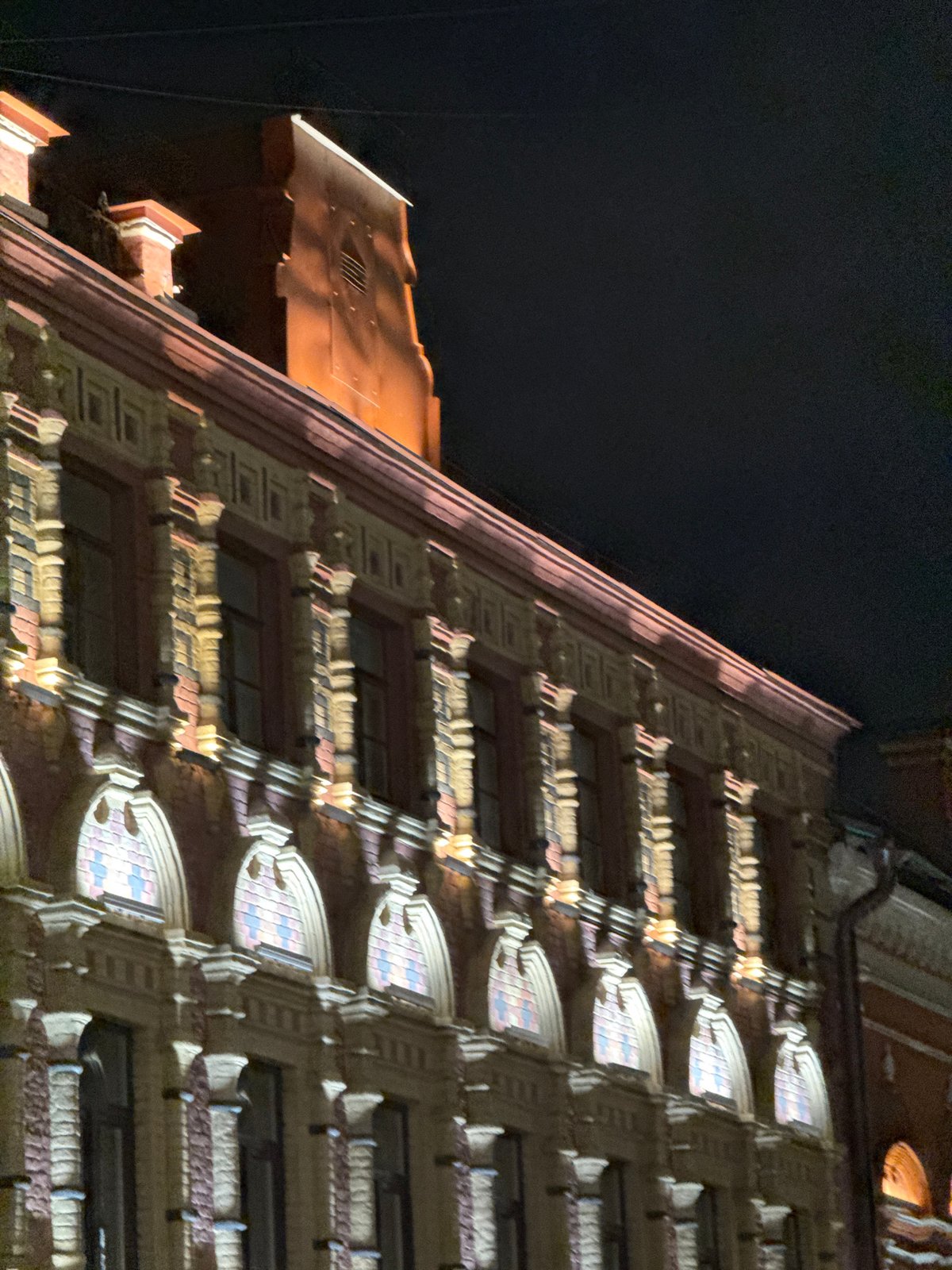 Nighttime architectural photography captures illuminated historic Moscow buildings