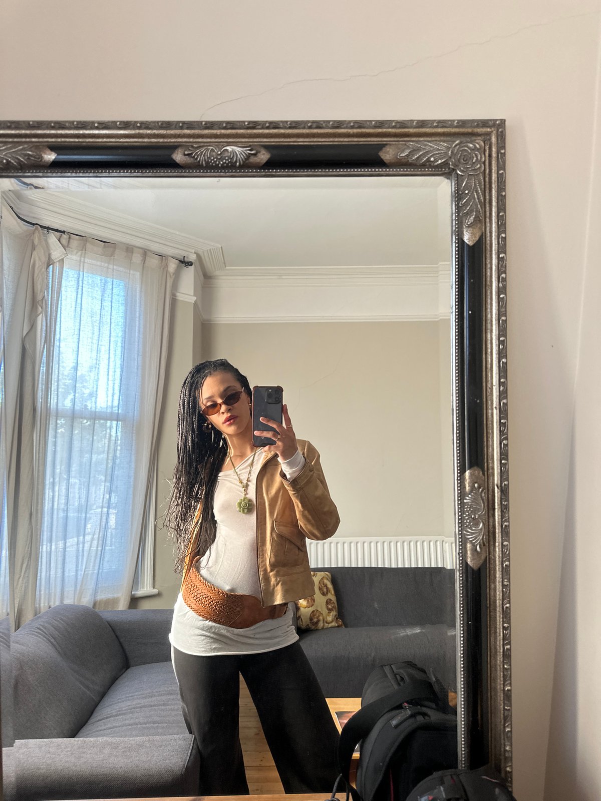 Woman takes mirror selfie in London living space