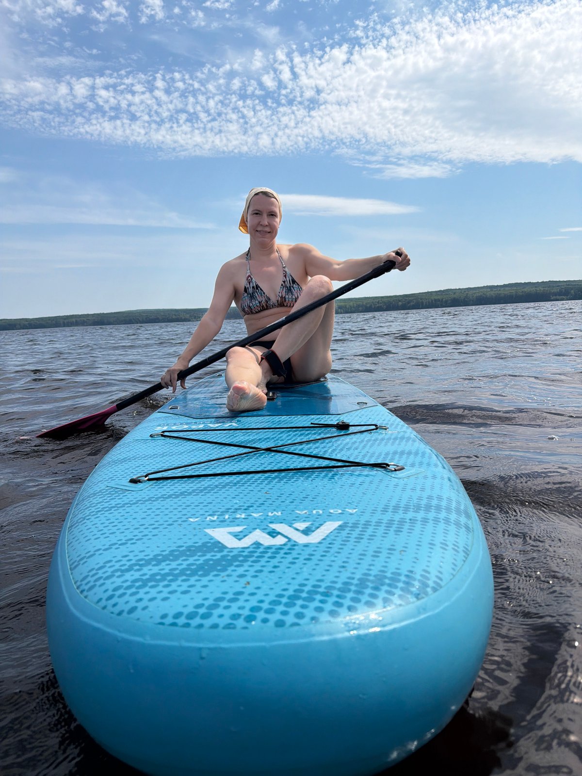 Stand-up paddleboarding on calm water near Chaikovsky, Russia