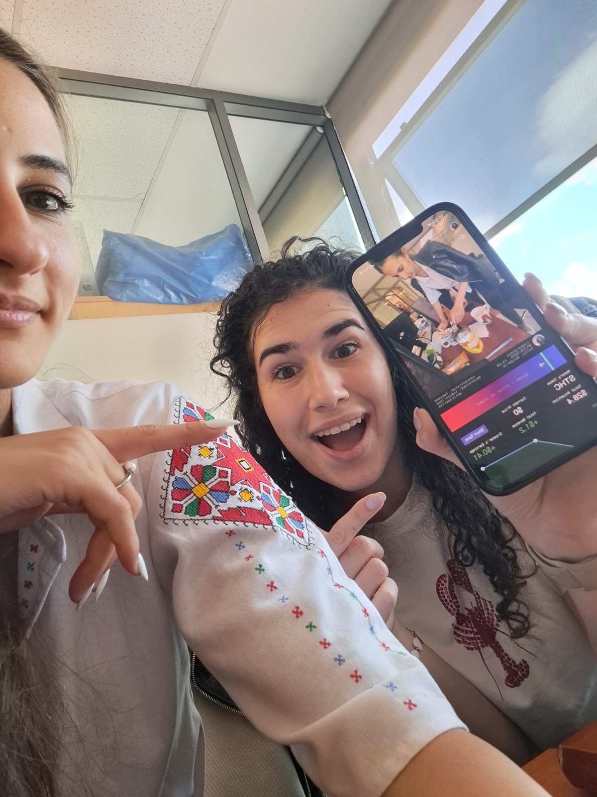 Two women share joyful moment in indoor selfie