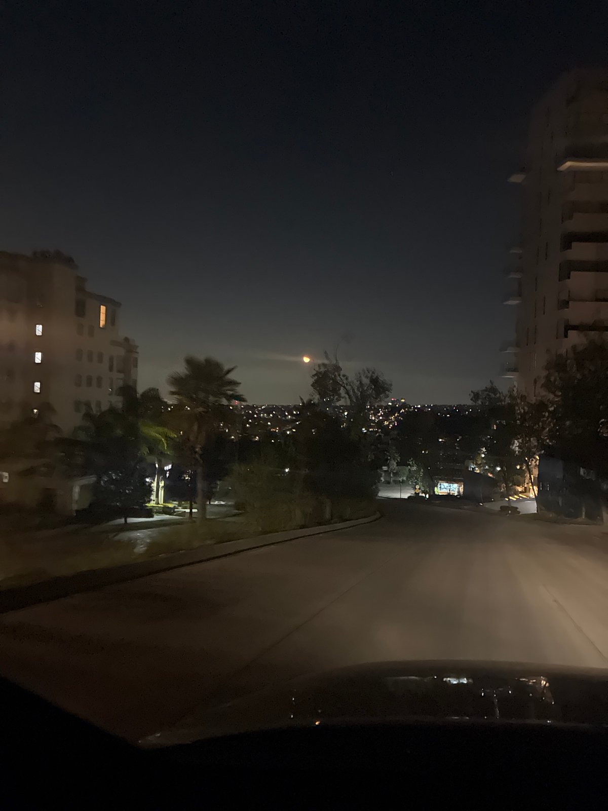 Nighttime street scene captured from vehicle in Huixquilucan, Mexico