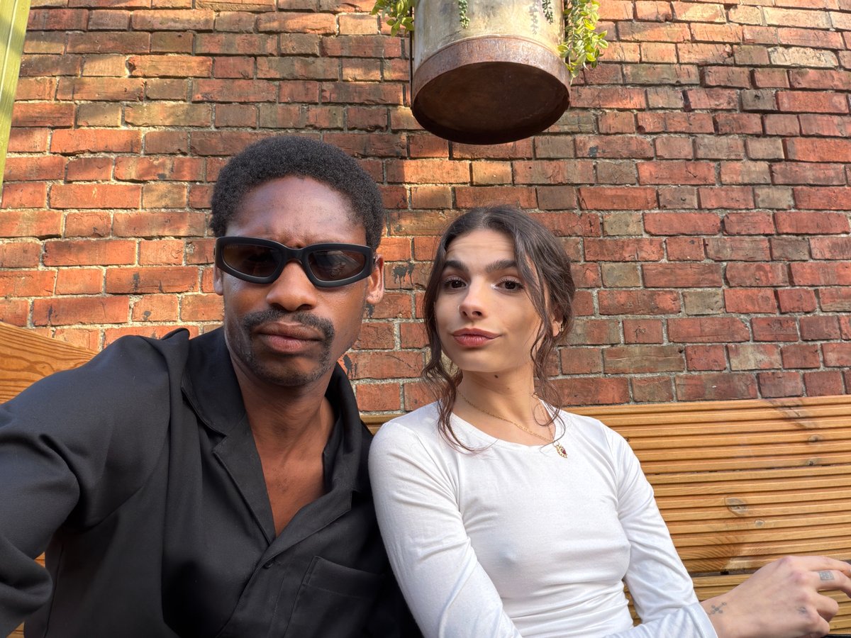 Two people photographed near brick wall in Folkestone