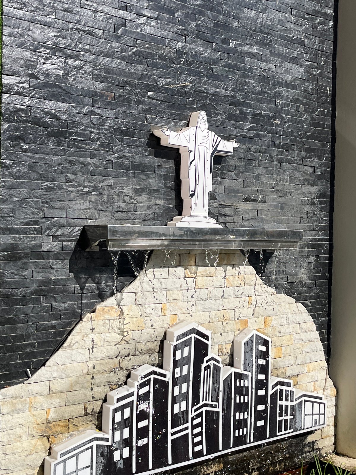 Stone-tiled architectural wall installation observed in urban setting