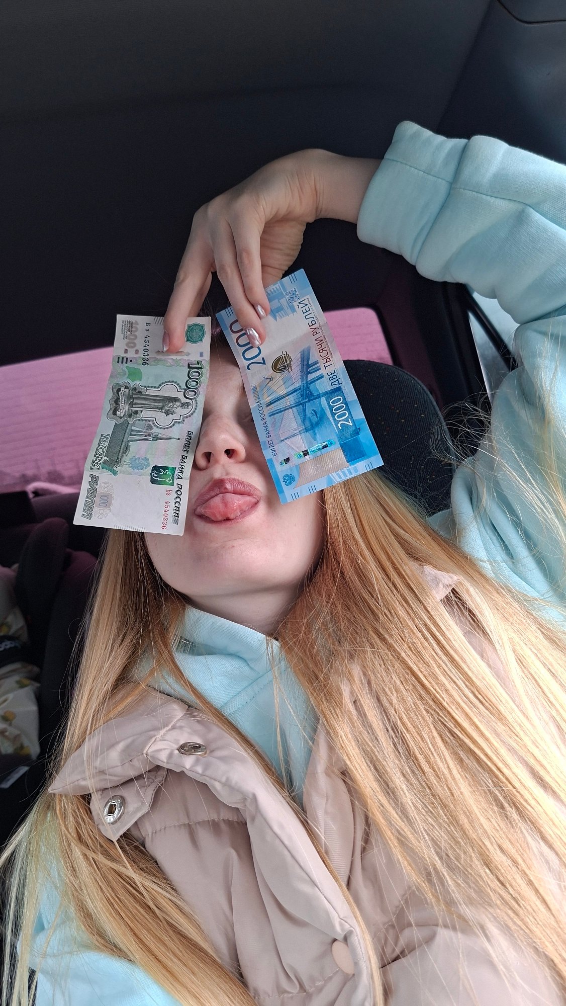 Woman displays cash, drives through Russian village