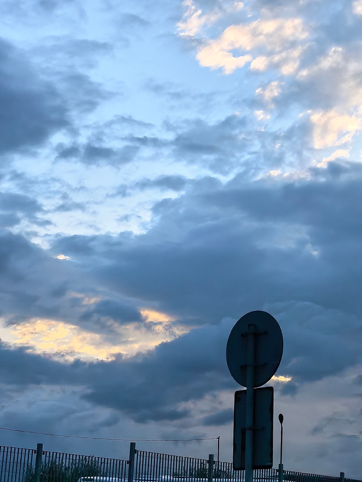 Dawn drive captured through wet streets under dramatic skies