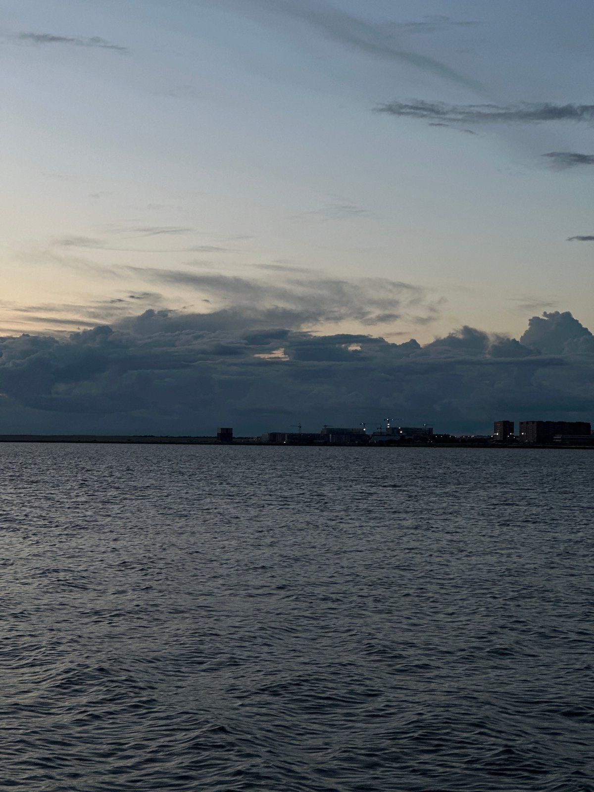 Dusk over Kokshetau — water, clouds, and a construction site