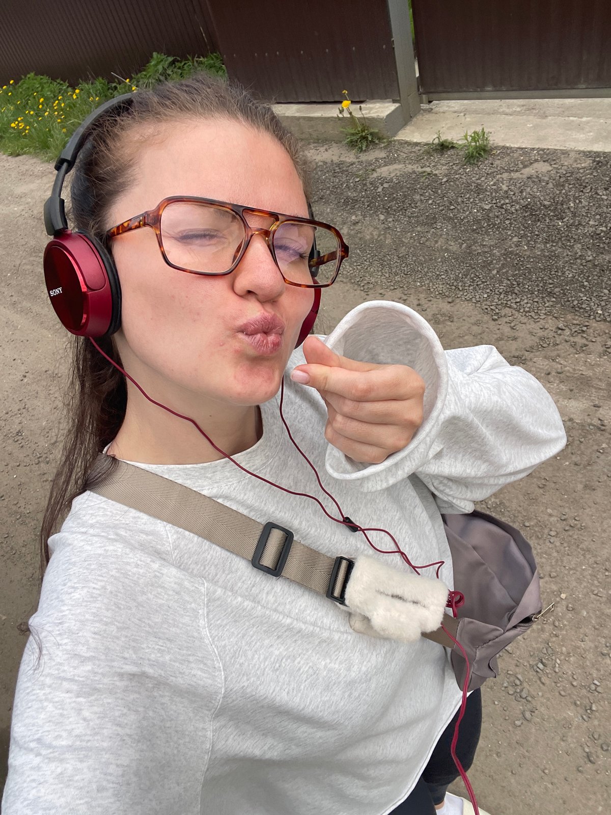 Person with red headphones photographed across Russian villages