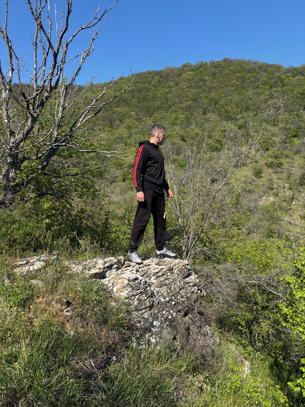 Man poses at scenic overlook in Goritsa, Bulgaria