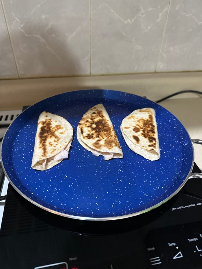 Late-night quesadilla preparation captured in Puebla kitchen