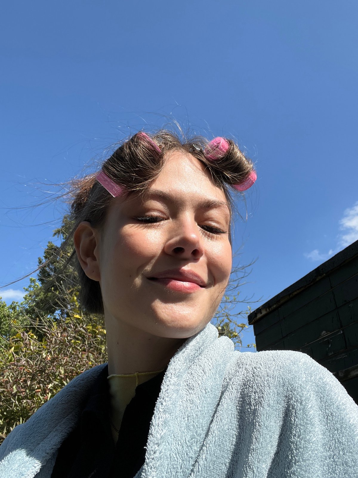 Young person in curlers photographed in London morning routine
