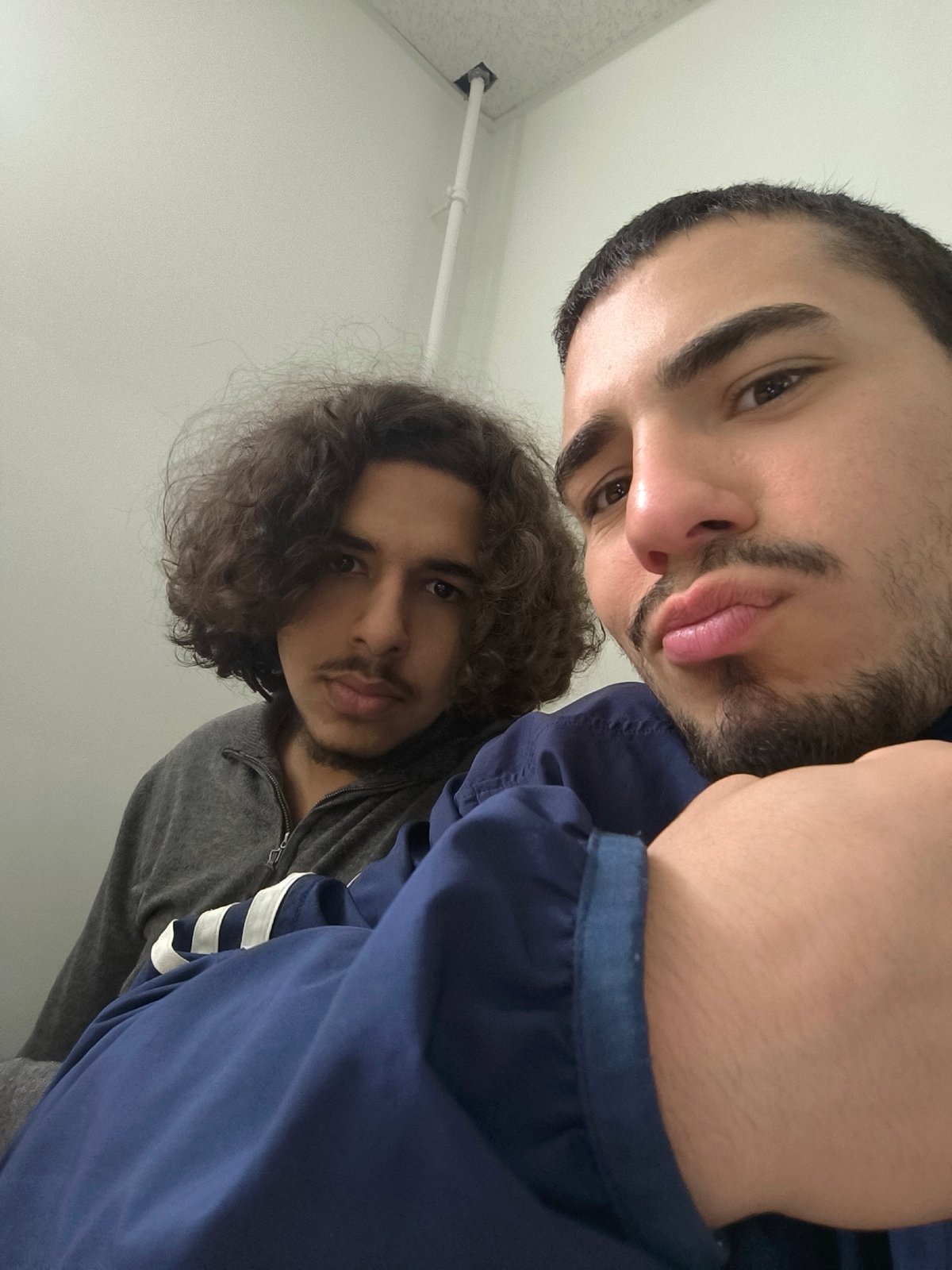Two young men pose for indoor photo in Schiltigheim
