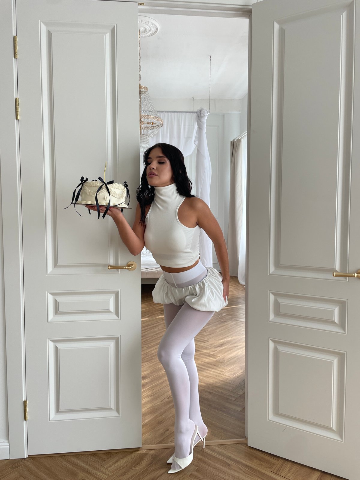 Woman poses with cake in elegant Kazan interior