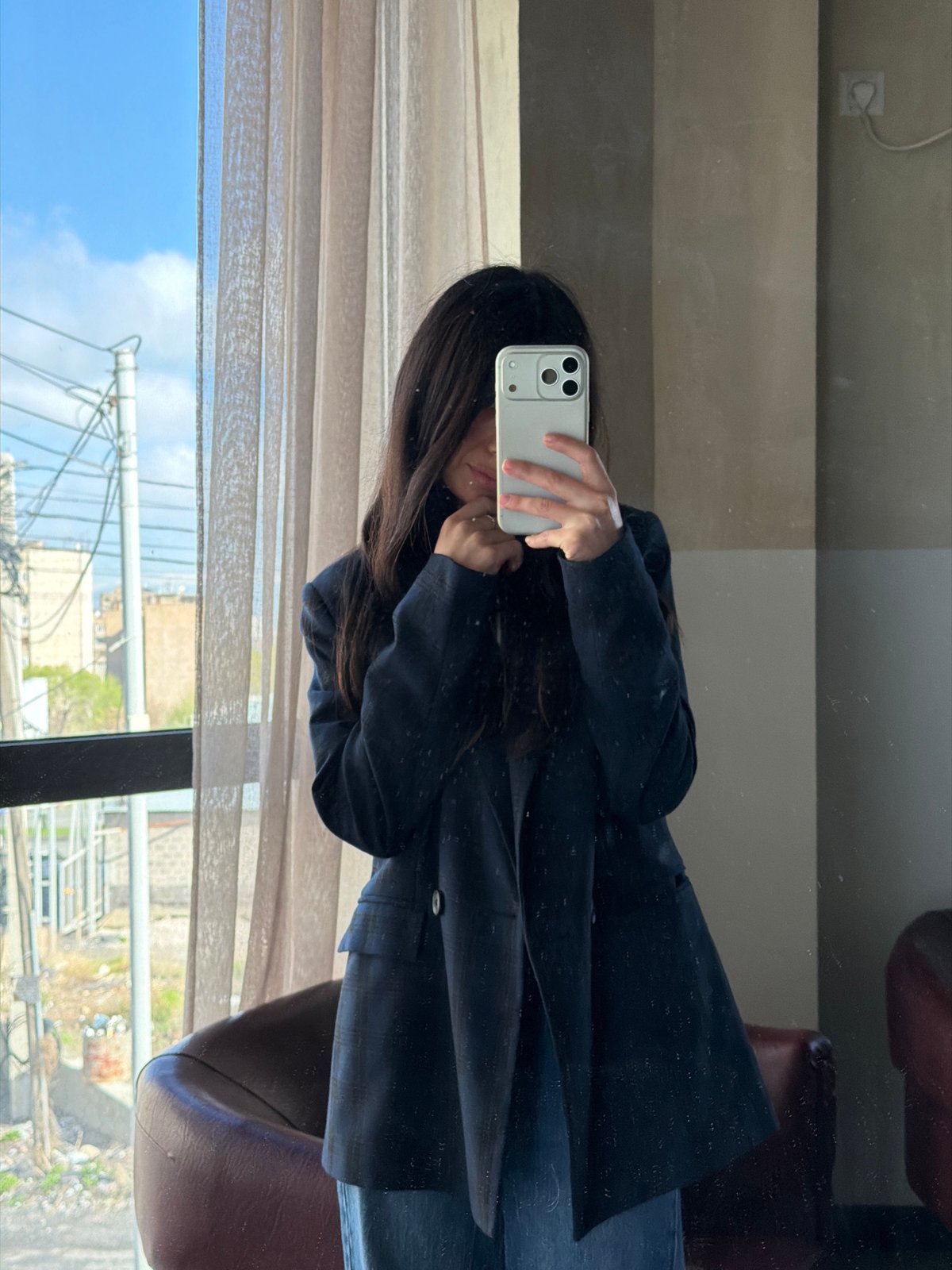 Morning mirror selfie captures Yerevan cityscape reflection