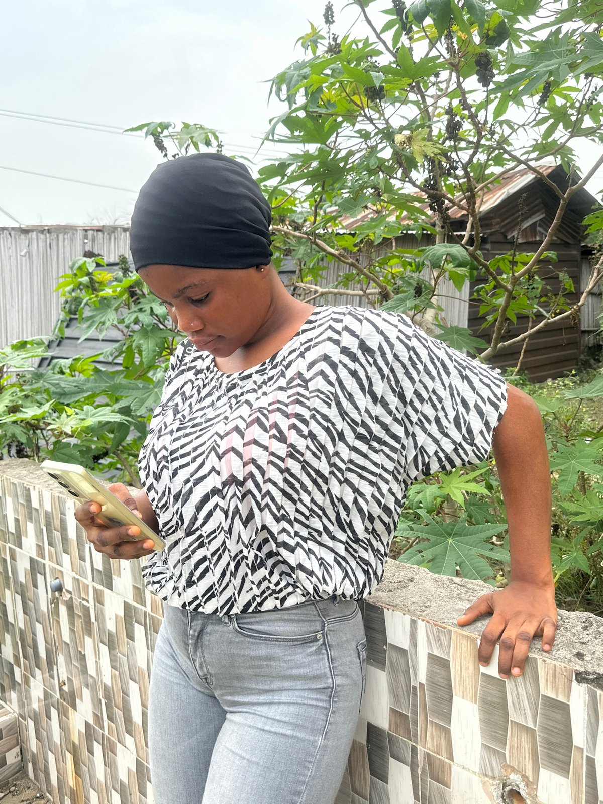 Woman documented using smartphone outdoors in Badagry, Nigeria