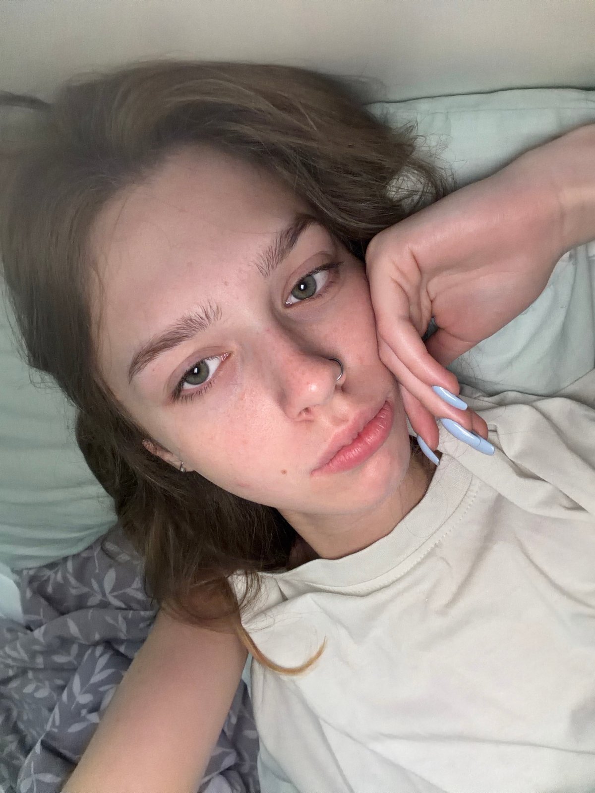 Quiet morning in bed with a cat and blue flowers