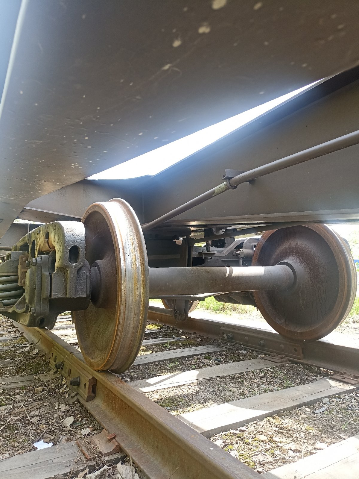 Railway car components and tracks documented in mixed urban area