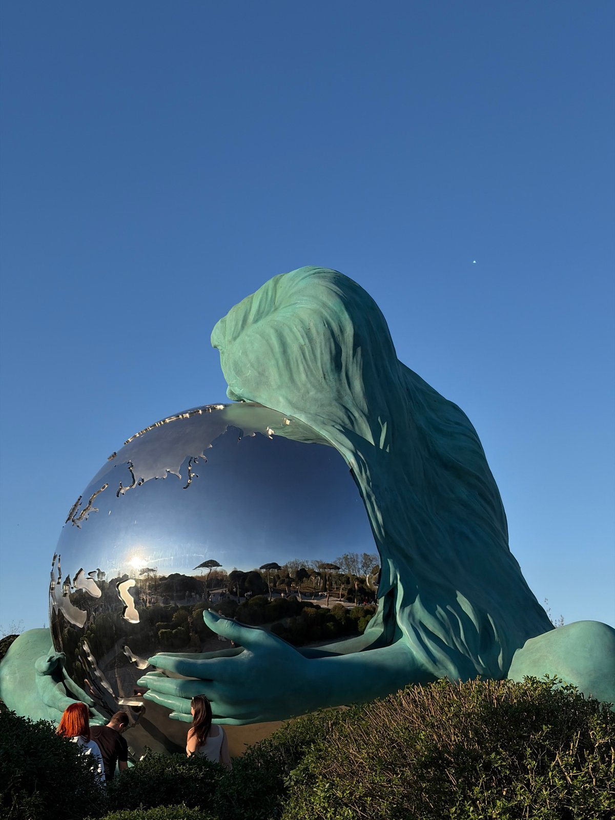 Krasnodar monument featuring woman holding globe photographed by visitors
