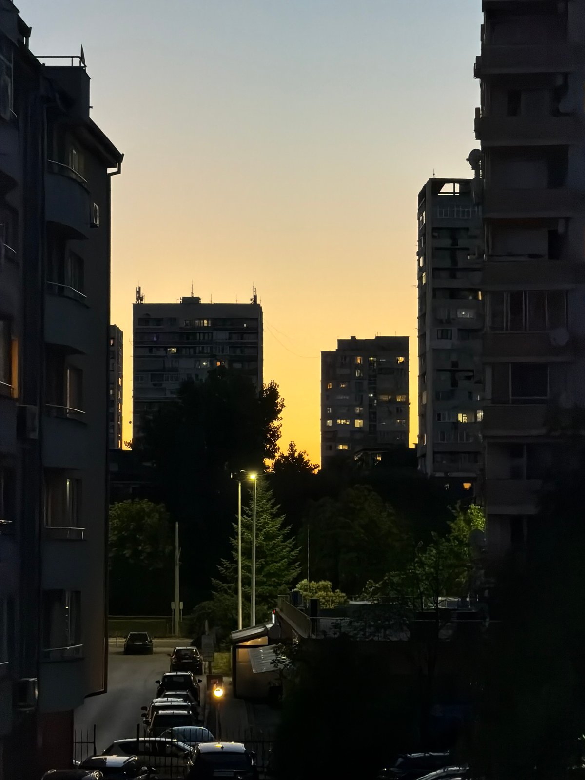 Sofia apartment blocks at dusk, sky shifting blue to orange