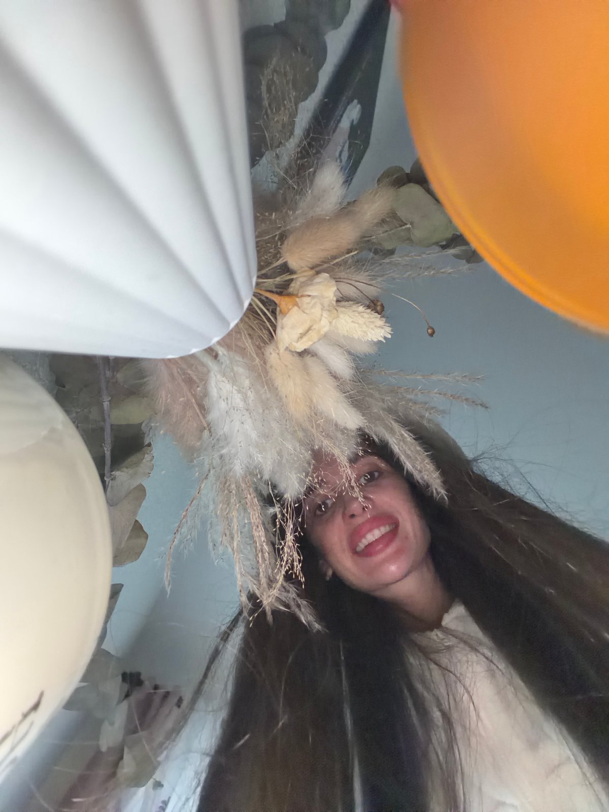 Person takes selfies, holds paper astronaut in Saint Petersburg
