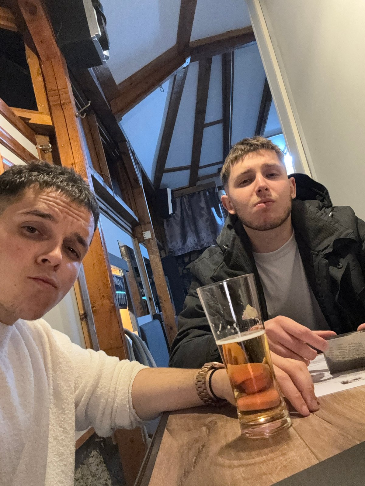 Two men share beers at Kostinbrod bar gathering