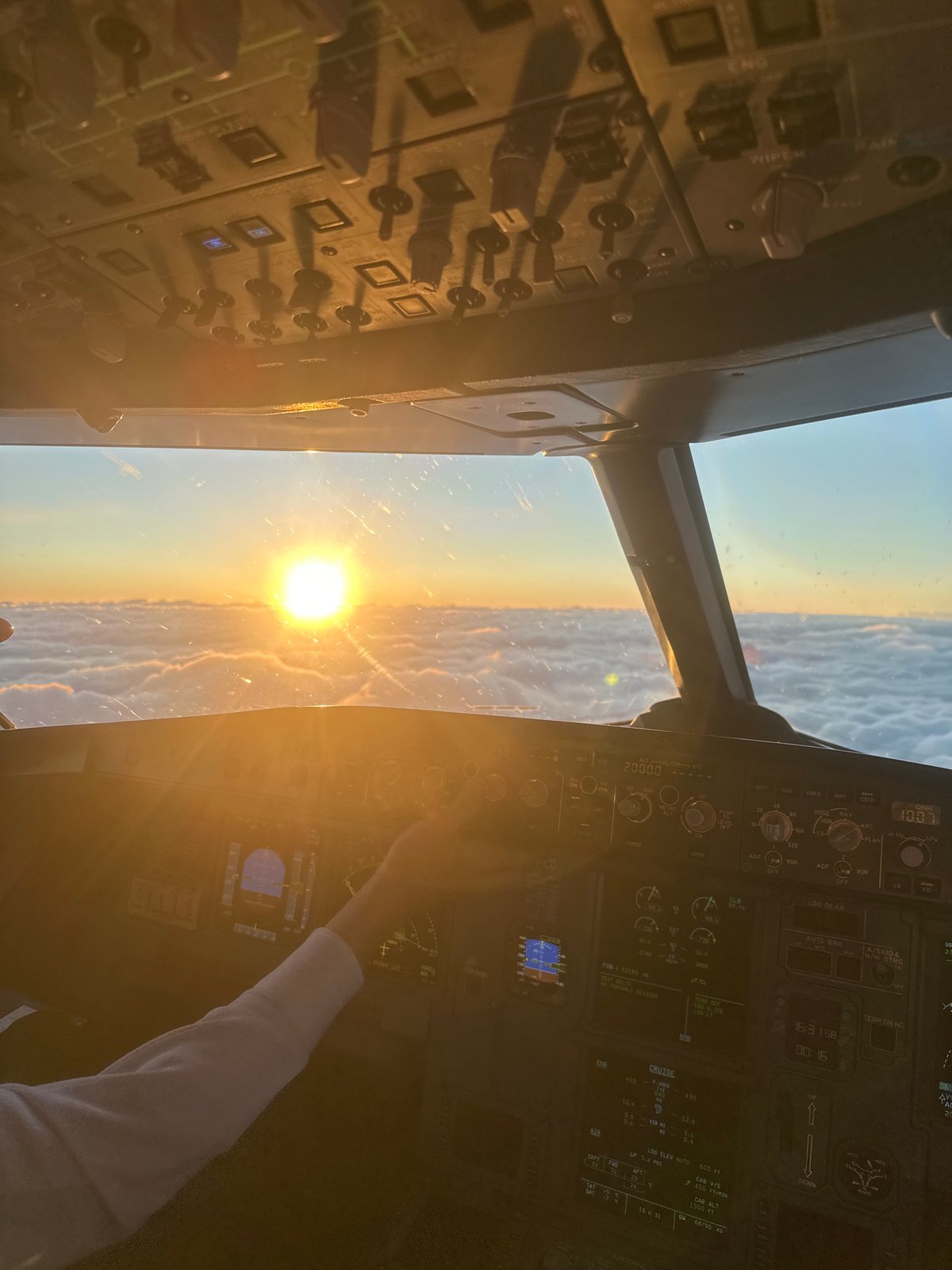 Aircraft cockpit captures sunset view over Khimki, Russia