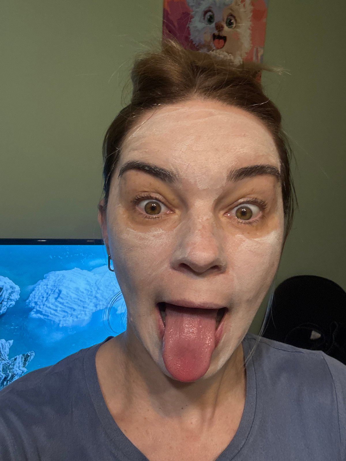Person documents facial mask routine with white lilac flowers