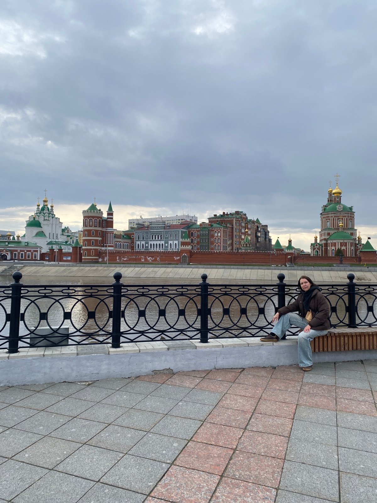 Visitors pose along Yoshkar-Ola waterfront during afternoon outing