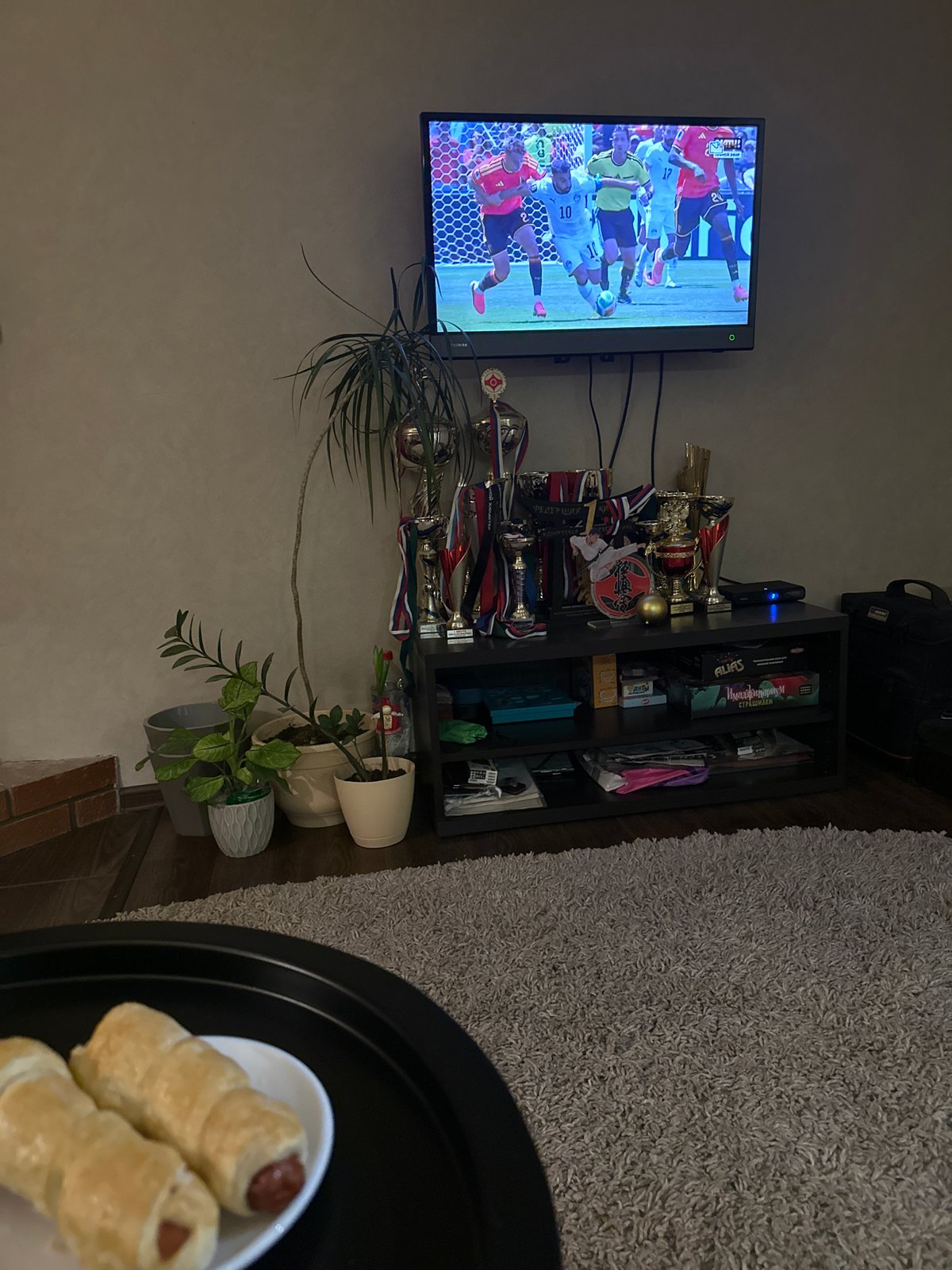 Football on TV, sushi on the table, evening in.