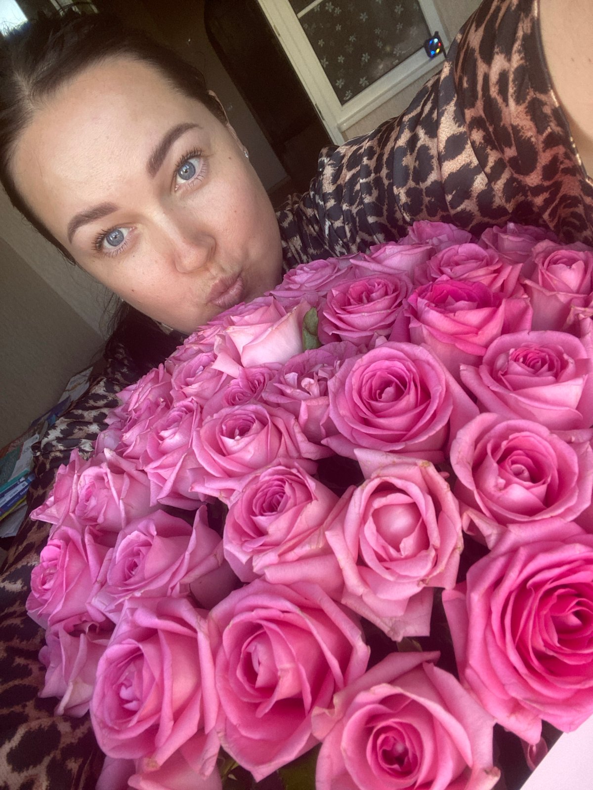 Mother and child share pink roses in Sochi home