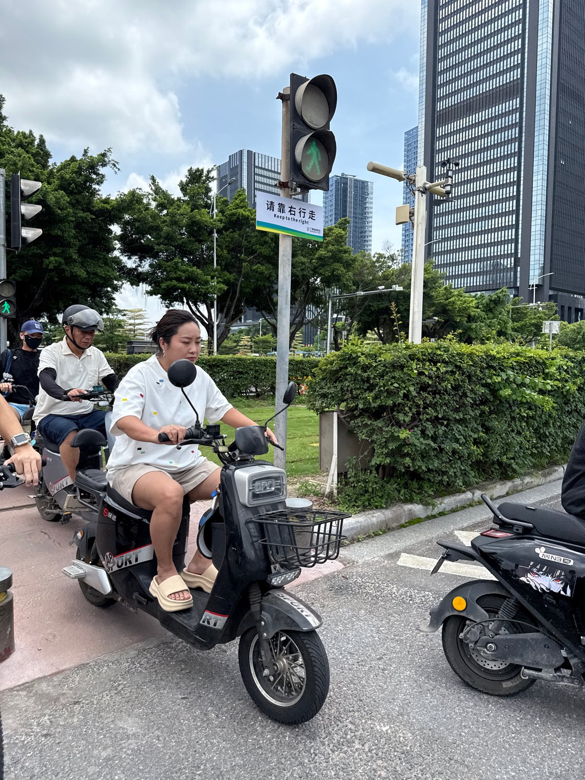 Haizhu District intersection buzzing with scooters and delivery traffic