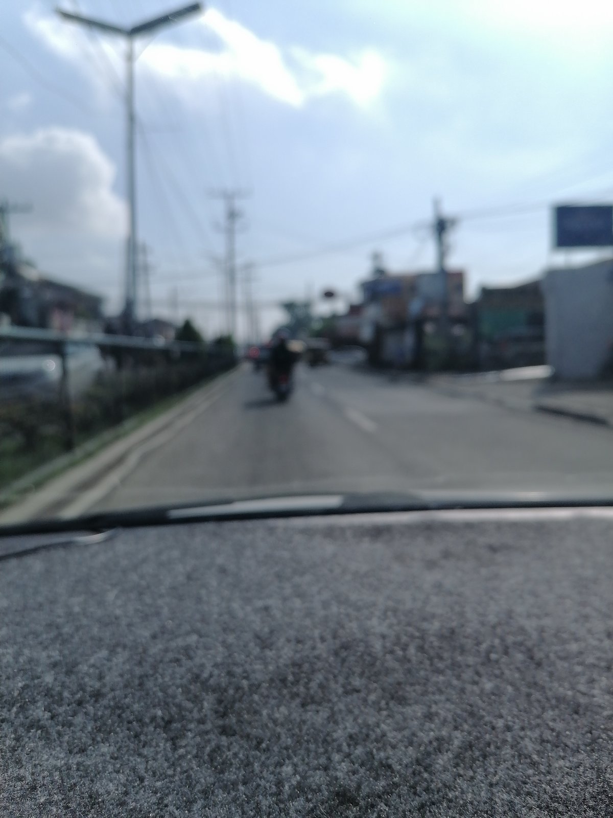 Blurred street view captured from vehicle in Davao City