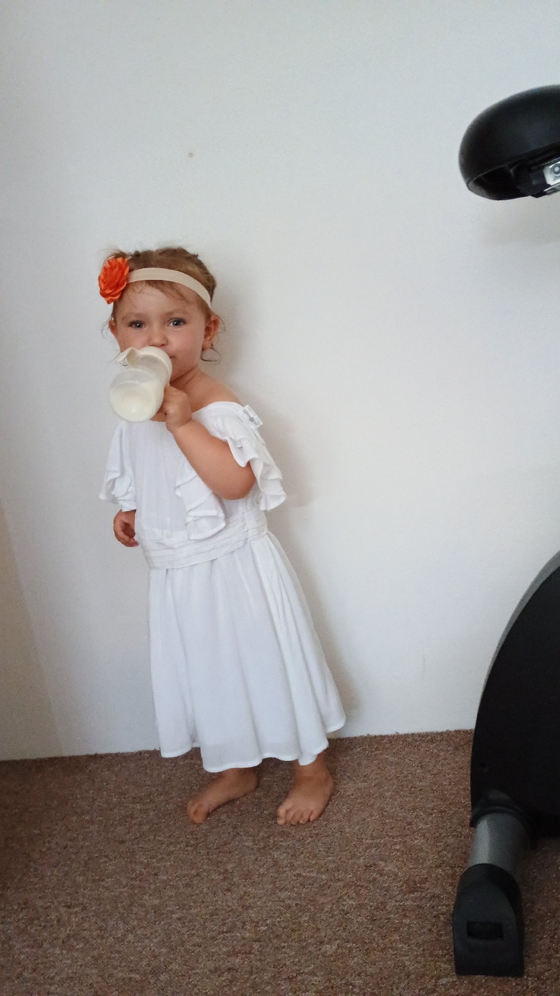 Toddler explores apartment and plays around exercise bike in Sokolov
