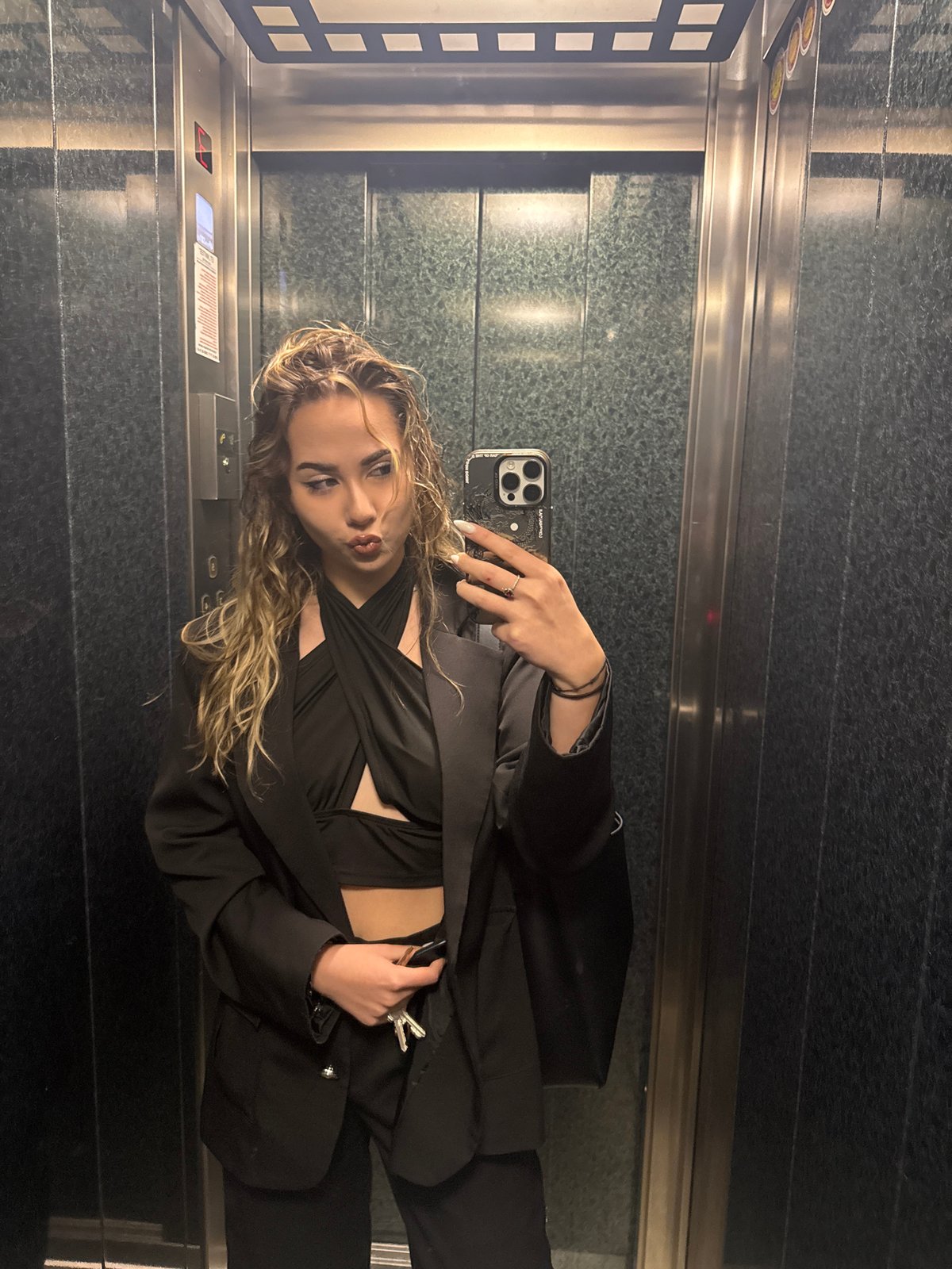 Woman takes selfies with rose in Blagoevgrad elevator, street