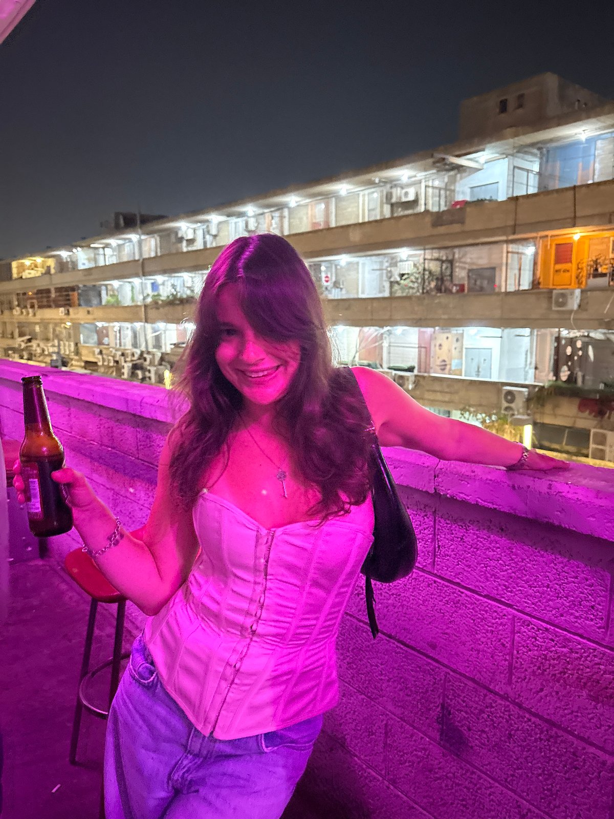 Nighttime rooftop gathering with DJ performance in Tel-Aviv