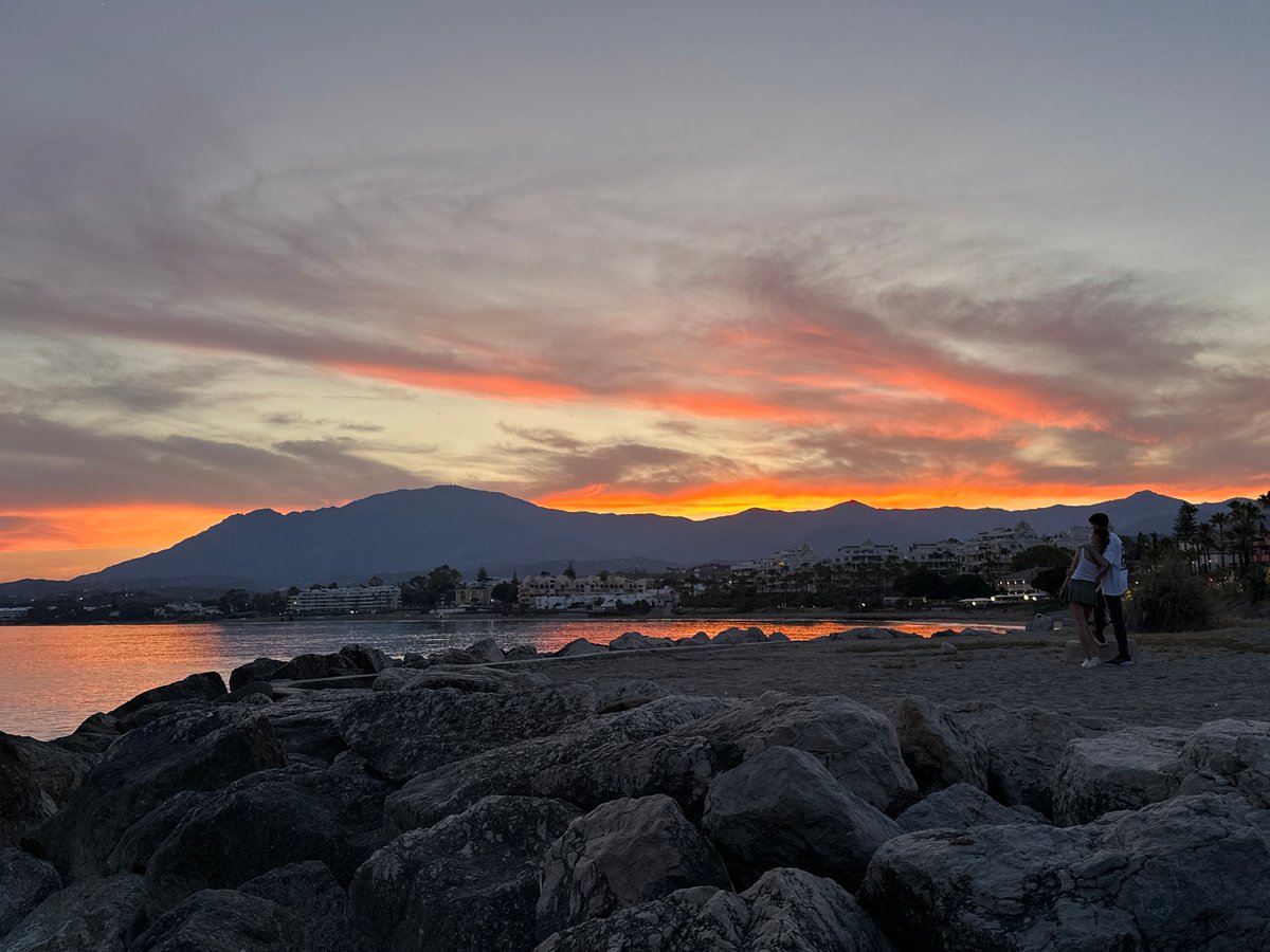 Sunset on a rocky Costa del Sol beach, July evening