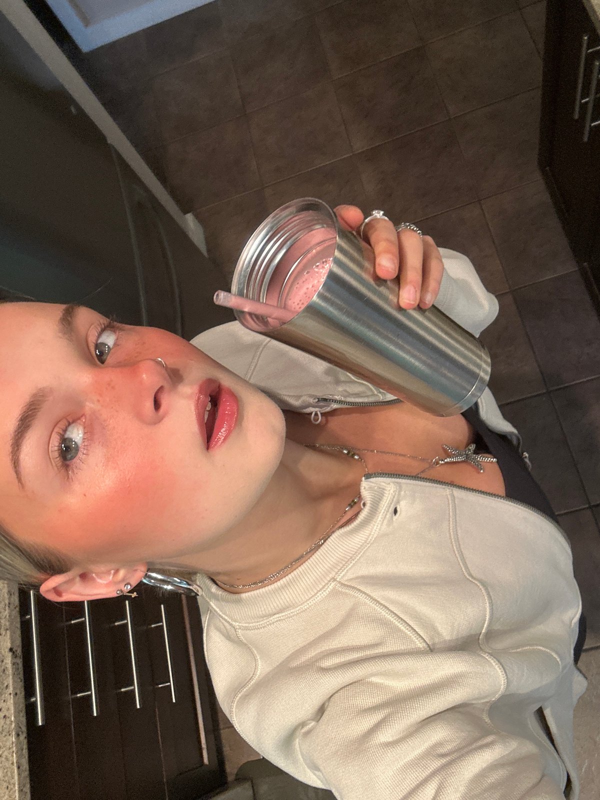Young woman photographed with pink drink in Whistler kitchen