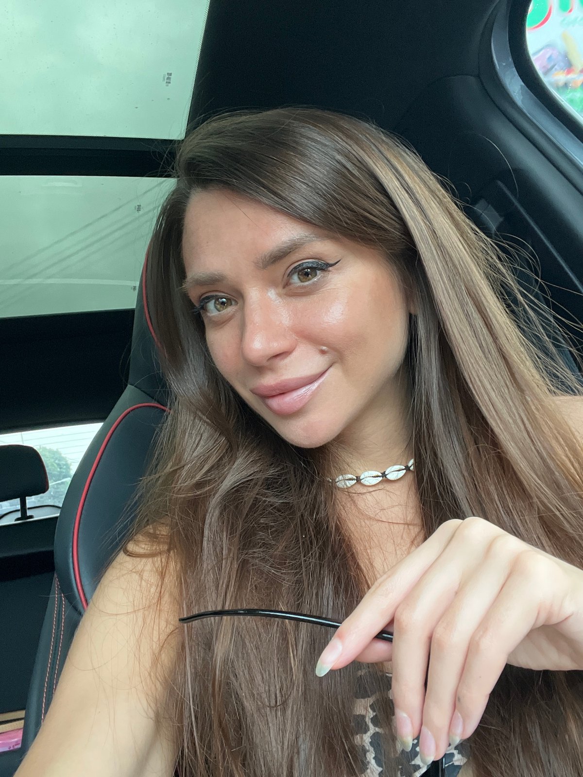 Woman takes car selfies in Baan Hua Thanon