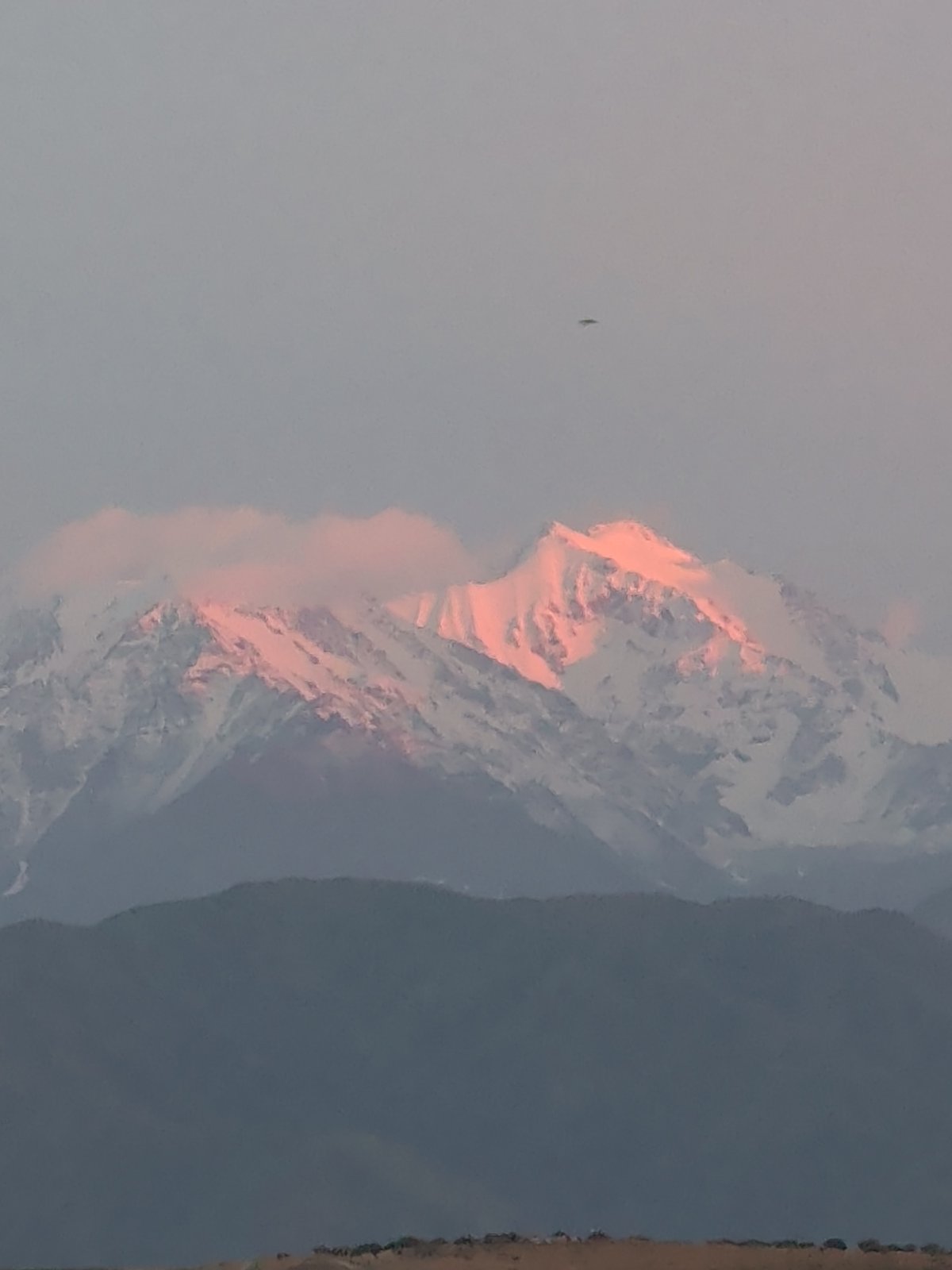Snow-capped Tian Shan peaks glow at sunset near Bishkek