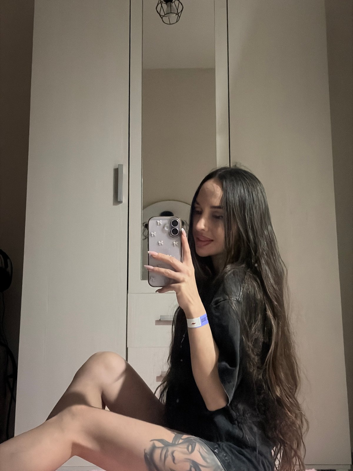 Woman takes selfies in front of wardrobe in Saint Petersburg
