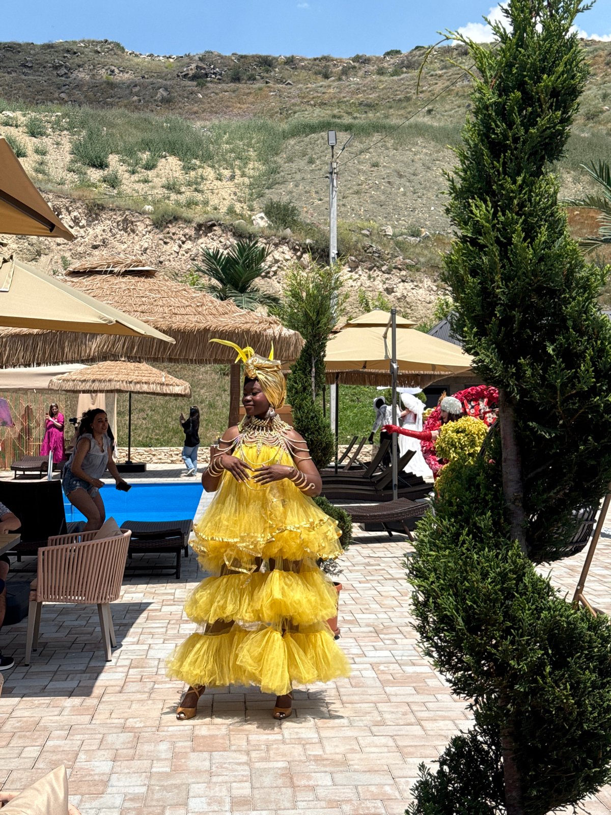 Elaborately costumed gathering at an outdoor venue in Ptghni
