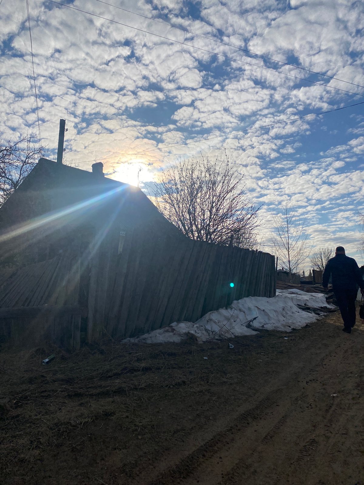 Person photographs self in rural Russian village