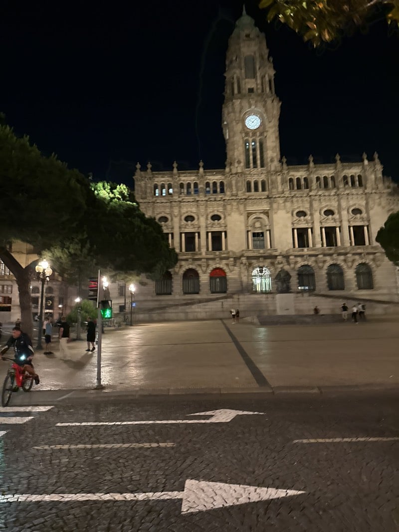 Evening activity captured around illuminated Porto City Hall