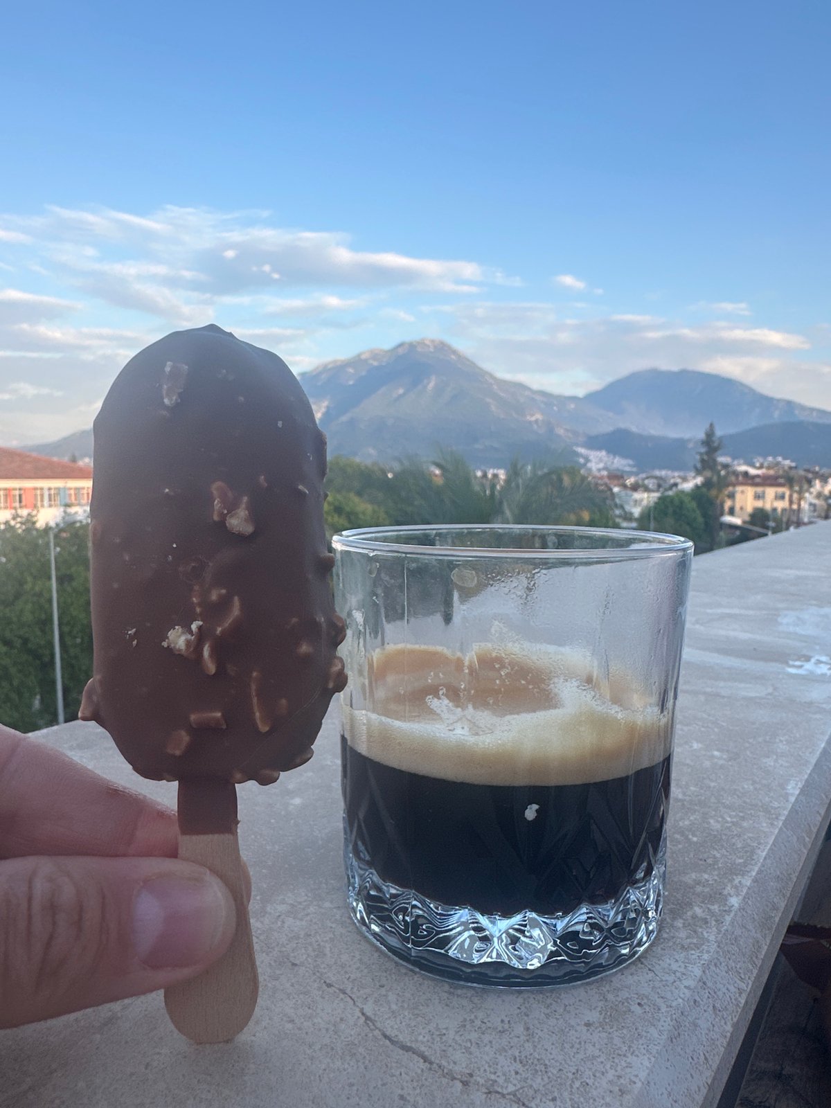 Person enjoys ice cream with espresso in Fethiye, Turkey