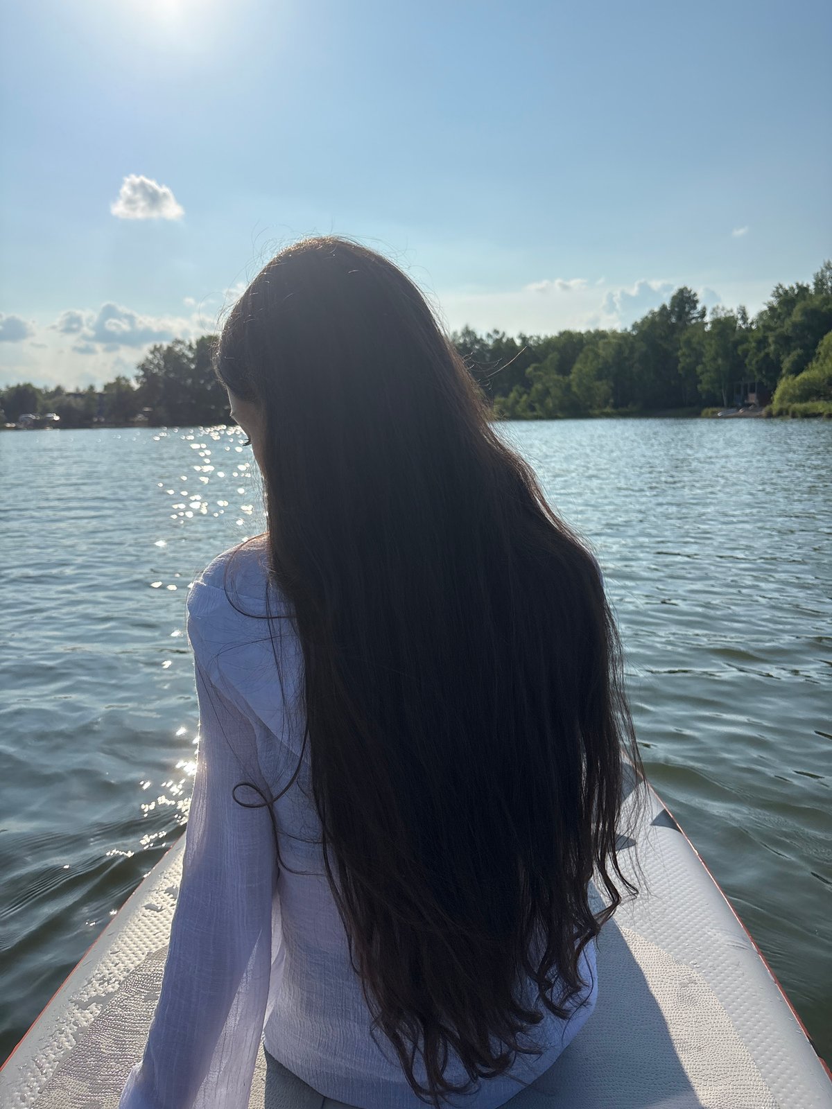 Paddleboard session on a calm Russian lake, summer morning