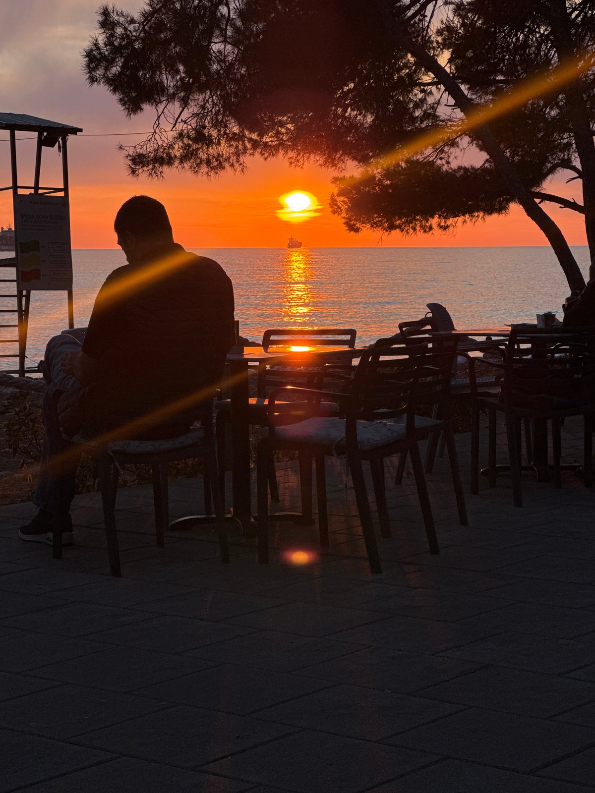 Person watches sunset over Adriatic Sea in Bar, Montenegro