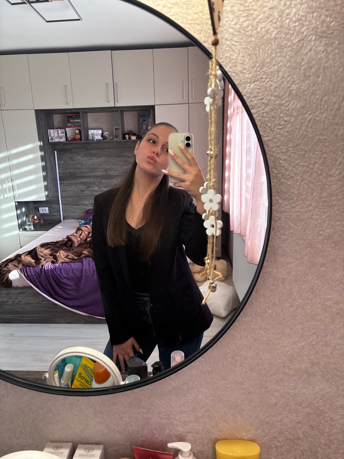 Woman takes mirror selfies in Bulgarovo bedroom early morning